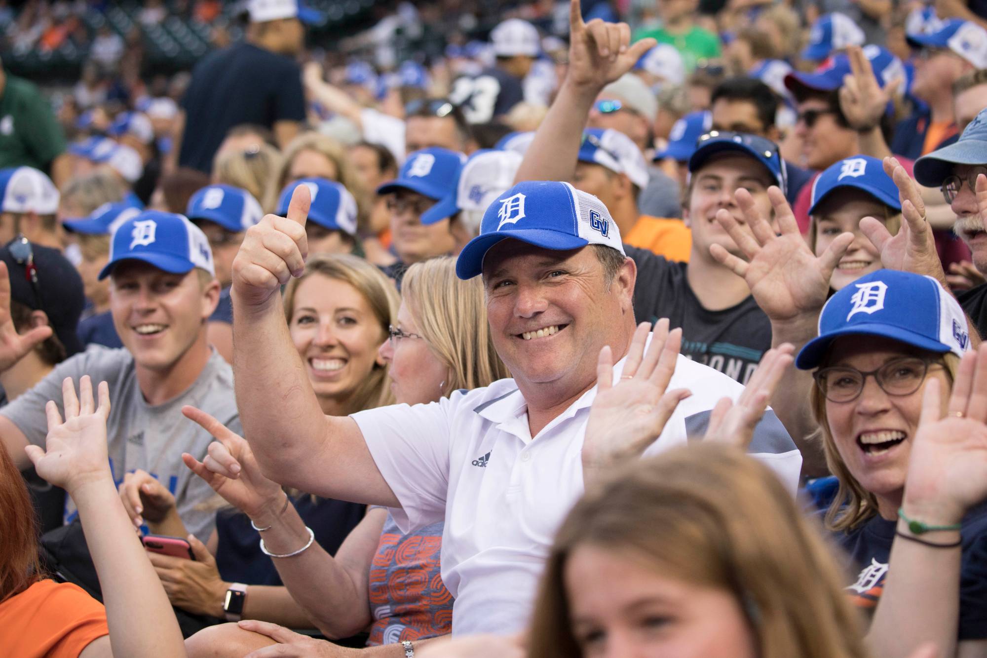 Fans wearing Detroit baseball caps at a game